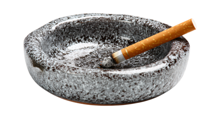 Cigarette resting in a ceramic ashtray with ash and a burnt end