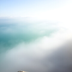 Fog Cascading Against a Teal Horizon with Scenic Mist and Soft Brightness