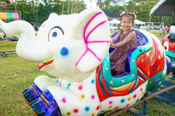 Little girl enjoy outdoor amusement city park festival