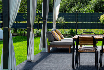 The terrace behind the house is made of beams, the roof is covered with polycarbonate.