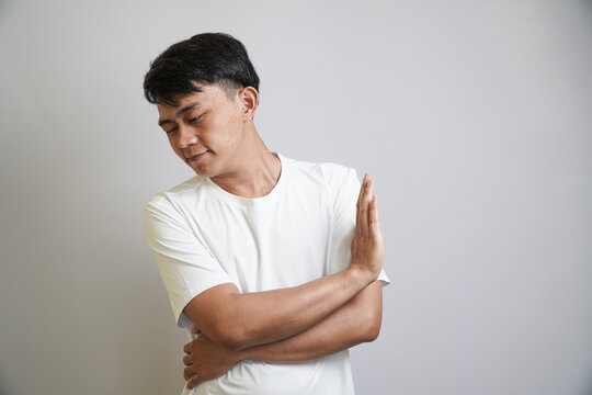 Stop. Concerned Asian man showing refusal sign, saying no, raise awareness, standing over white background