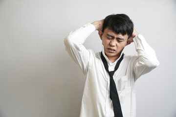 Frontal shot of a frustrated male professional, suffering from a severe headache or mental...
