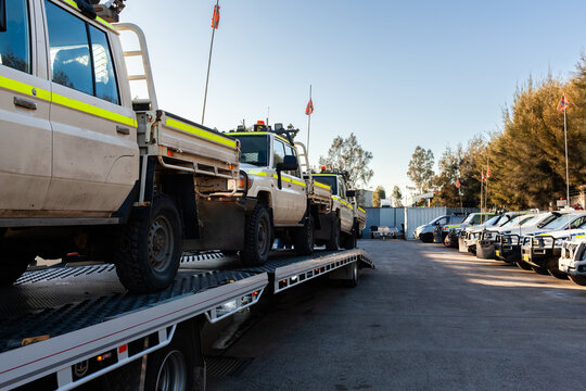 Mining fleet vehicles loaded on a flatbed trailer of truck being delivered to mechanics for repairs