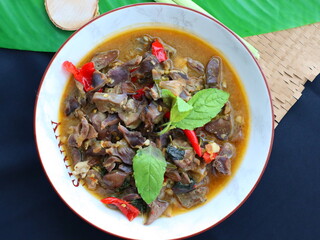 Spicy Thai stir-fry with chicken offal, cooked with garlic, chili, and fresh holy basil leaves, delivering a rich, aromatic, and flavorful dish perfect with steamed rice.