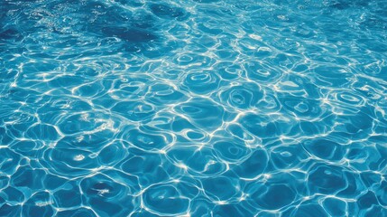 Obraz premium A shimmering surface of clear blue water, capturing light reflections and ripples, creating a tranquil and refreshing ambiance.