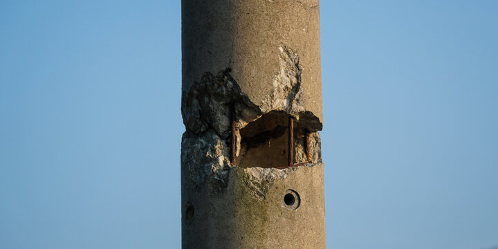 Detail of a Damaged and Cracked Concrete Electric Pole