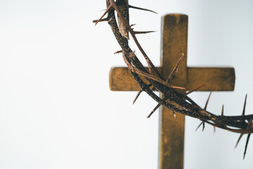 Cross and crown of thorns, often seen in gold crucifix symbols, represent the sacrifice of Jesus...