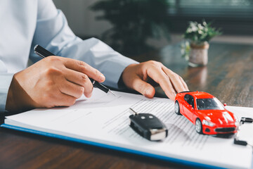 Customer signing insurance document lease agreement table, writing signature contract buying...