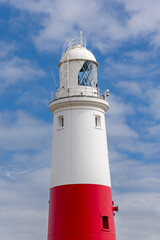 The iconic Portland Bill Lighthouse in Dorset, England on a bright sunny day.