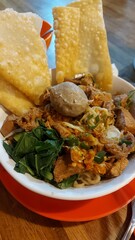 a bowl of noodle and meatball