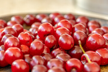 a Wooden a bowl full of ripe red cherries close up