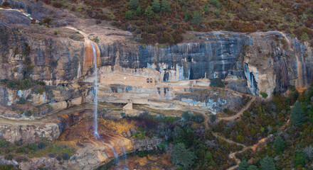 An aerial drone view of the Hermitages of San Cornelio and La Cueva, and the Chorro Waterfall in...