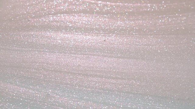 Applying pink nail polish, manicure concept. Spilled UV gel, enamel, polish with brush on surface. Beauty salon, nail care product. Nail art. Fashion background. Slow motion.