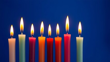 A row of colorful tapered candles with glowing flames creates a warm and festive ambiance.