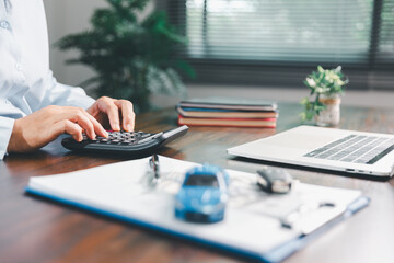 Dealership service desk, professional car salesman assists client with sale, finance documents for vehicle, ensuring smooth business transaction in retail transportation sector through signed contract