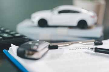 Client legal contract and finance document for business deal involving vehicle, agreements cover car loan, insurance, investment terms, with car key handed over to complete transaction.