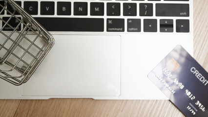 Laptop keyboard with shopping cart and credit card symbolizes online shopping and e commerce convenience. image highlights digital transactions and modern consumer habits