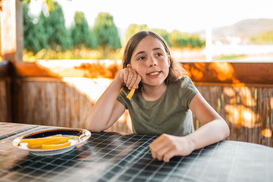 Chid eats french fries for lunch. Healthy nutrition for children concept.