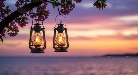 Two vintage lanterns hanging from a cherry blossom branch, with a romantic sunset over the sea creating a peaceful and serene atmosphere