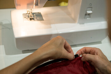 Female seamstress sewing haute couture clothing