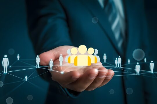 Human resources management concept featuring a hand holding a group of people icons representing teamwork collaboration and the importance of human capital in
