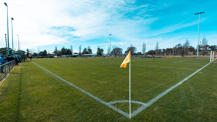Soccer field corner with yellow flag.