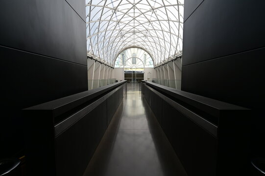 Longview of  a corridor with a skylight roof in a museum in London.