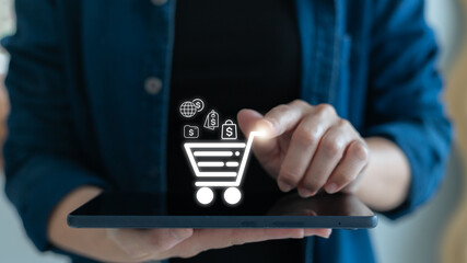 Woman using digital tablet for online shopping with e-commerce icons, shopping cart, and digital...