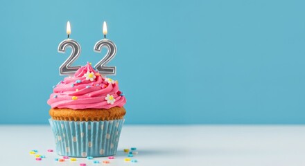 22nd Birthday Treat Pink Cupcake with Candles on Blue.