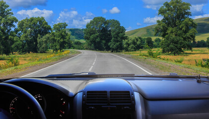 Fototapeta premium Car driving on beautiful country road in hilly area