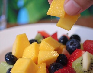 Close up of fresh fruit salad with mango blueberries strawberries and kiwi slices