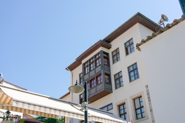 White building with a balcony and a lamp post