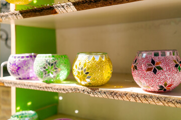 Shelf with a variety of colored glass vases