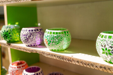 Shelf with a variety of colored glass vases