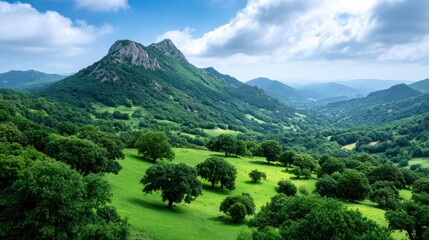 Lush green landscape with rolling hills and mountains under a bright blue sky, showcasing a serene and tranquil nature scene.
