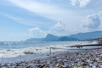 Beach with a large body of water and a rocky shore