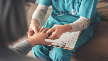 Healthy lifestyle and medical concept, the doctor examines the elderly patient's trembling hands	