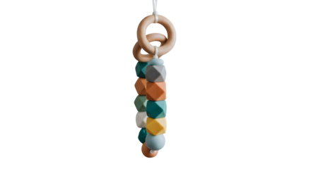 Colorful geometric baby toy hangs with soft lighting for product display, website design, kids' branding.