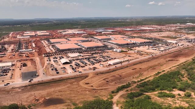Drone aerial view of hyperscale data center construction with steel framework, cranes, and machinery, highlighting technology infrastructure development in progress.