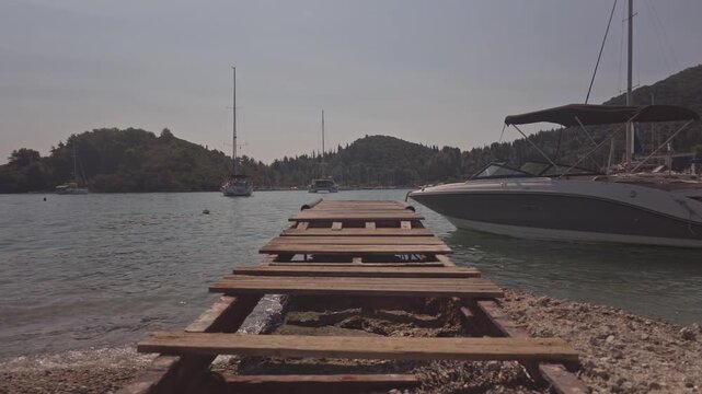 wooden gang plank on beach in nydri port, lefkada