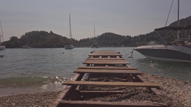 wooden gang plank on beach in nydri port, lefkada