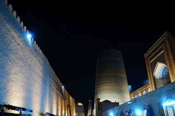 Kalta-minor Minaret and Walled Fortress known as Itchan Kala in Khiva, Uzbekistan -...
