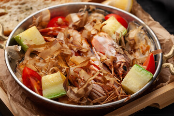 Delicious seafood dish with fresh vegetables served in a traditional bowl at a coastal restaurant