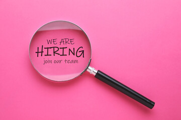 We are hiring, join our team. Inscription and magnifying glass on pink background, top view
