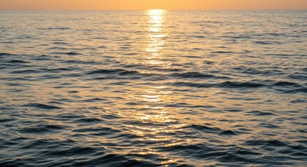 Fototapeta premium Golden Hour Seascape: Tranquil Ocean Waves at Sunset, Reflecting Sunlight