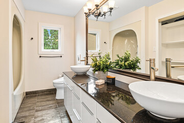 Bathroom with a white sink and a black countertop
