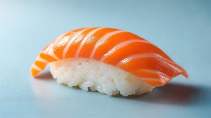 Single piece of salmon sushi on a light blue surface