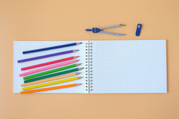 Study desk with notebooks and colored pencils .