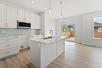Kitchen with a white island and a sink