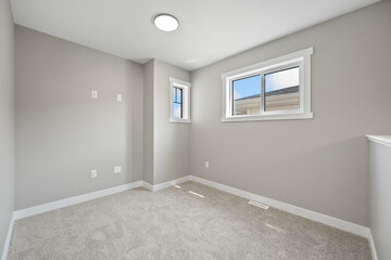 Very clean and empty room with a white wall and a white carpet